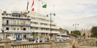 Cowes Week-Behind the Scenes image of RYLC emblazoned with bunting to the left and the RYS in the far right
